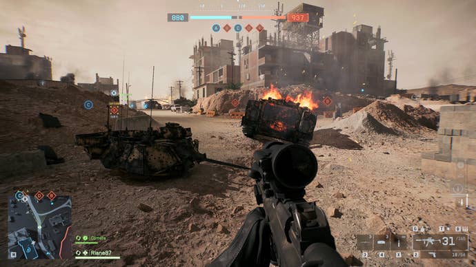 A screenshot of Battlefield 6, showing the player approaching the smouldering wreck of a tank, Egyptian apartment buildings looming in the background.