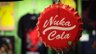 An oversized replica of a red Coke-like bottle top hanging in a shop window. On it are the words Nuka Cola.