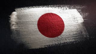 A Japanese white and red-dot flag, painted onto a rough surface.