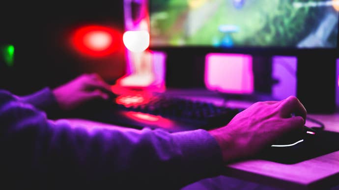 Close up of someone player a PC game with mouse and keyboard