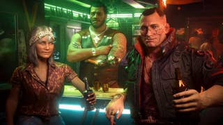 Three gruff-looking people at a neon-lit bar turn to face the camera. One is an older lady, one is a burly barman with their arms crossed, and one is a chunky leather jacket-wearing, broad-faced thug of a guy, with a beer in their hand. It's Jackie Welles from Cyberpunk 2077.