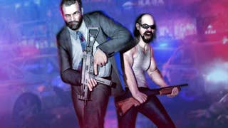 A man in a suit jacket and a man in  a vest stand, armed, painted in red and blue light from a police car behind them.