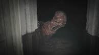 A huge, grotesque, disturbing baby monster flops around a dark hallway corner in Resident Evil Village.